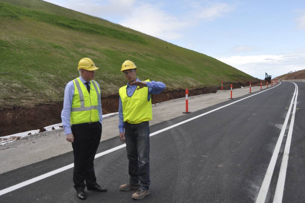 Kiama MP Gareth Ward and RMS project manager Adrian Rouse inspect the new works on Princes Highway. The northbound lanes have been completed ahead of schedule. Picture: BRENDAN CRABB