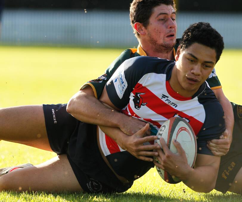 University's Nik Rangiuira is tackled by a Shoalhaven player. Picture: CHRISTOPHER CHAN