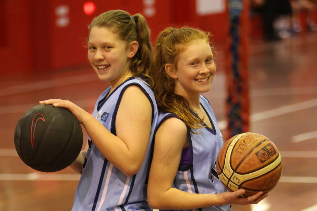 Having a ball: Mackenzie Roddam, left, and Ella Dent helped the NSW PSSA basketball side win gold at the Australian Championships. Picture: GREG TOTMAN