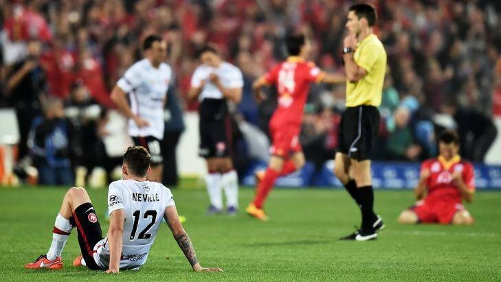 Unhappy Wanderer: Scott Neville sits dejected after the the Wanderers' 3-1 defeat to Adelaide United. Photo: Daniel Kalisz