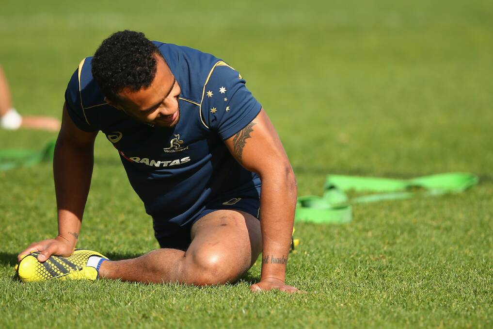Will Genia stretches during a Wallabies training session following his return from knee surgery. Picture: GETTY IMAGES