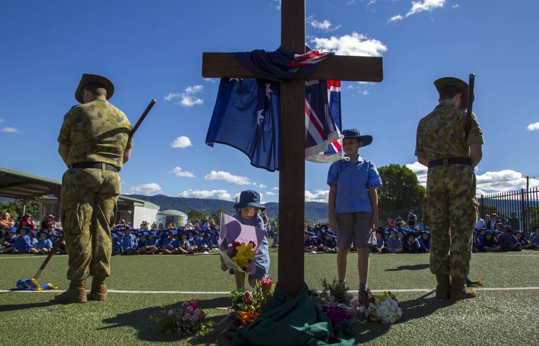 Floral tribute: Students at St John’s Primary school lay wreaths.