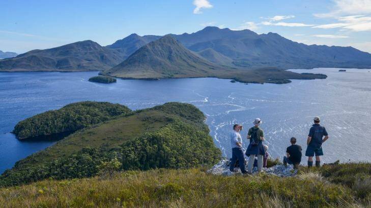 Guide Peter Marmion (L) with tourists from the Odalisque on top of Balmoral Hill, Port Davey. Photo: Supplied