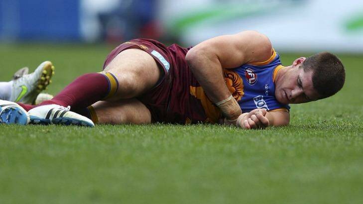 Jonathan Brown lies on the ground injured during the round 17 game against the Cats in 2011. Photo: Getty  Images