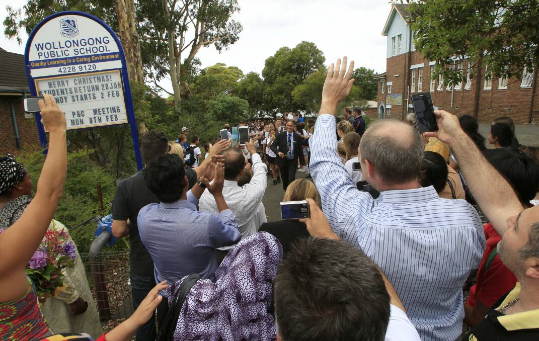 Wollongong Public School principal Harold Cosier leads the procession of departing year 6 students. Picture: ANDY ZAKELI