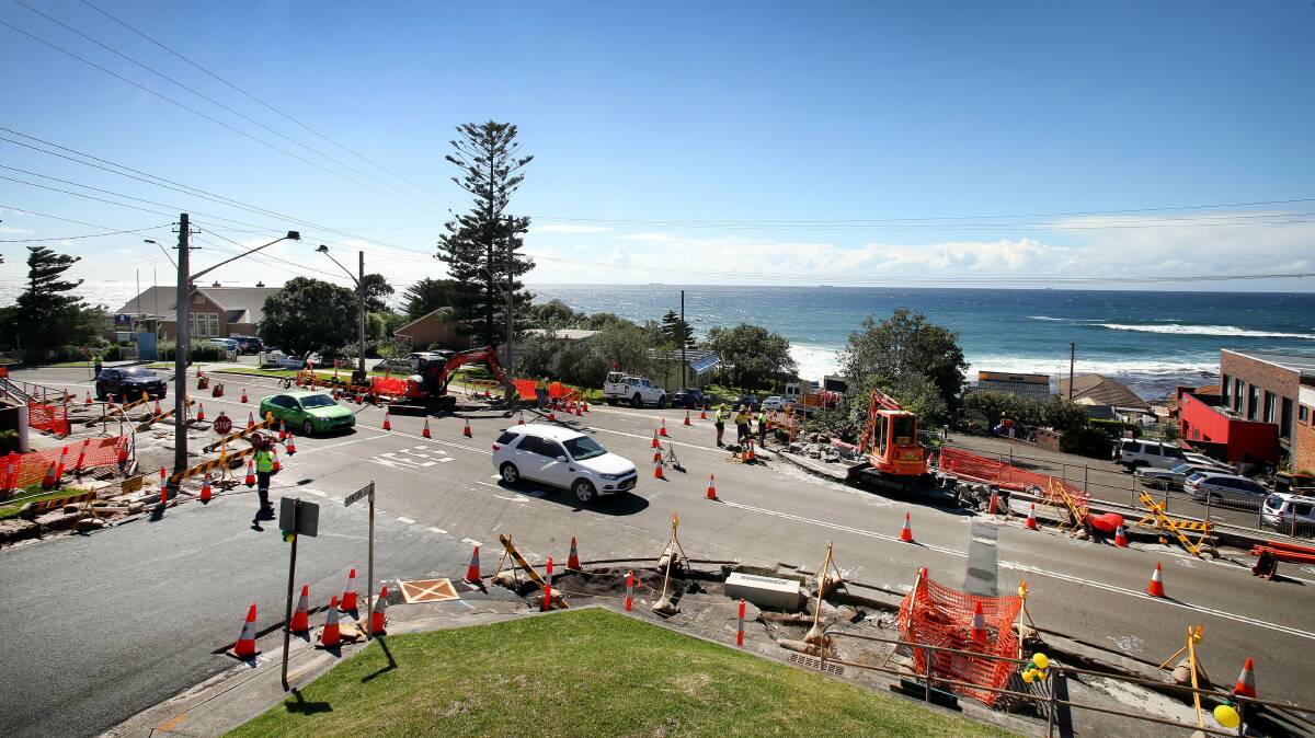 Safety first: Workmen get busy installing new traffic lights at the intersection of Lawrence Hargrave Drive and Rawson Street at Coledale.Picture: KIRK GILMOUR