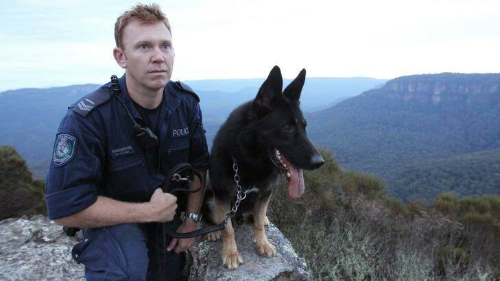 Senior Constable Luke Warburton, pictured with his dog Chuck, is in a critical but stable condition. Photo: David Darcy