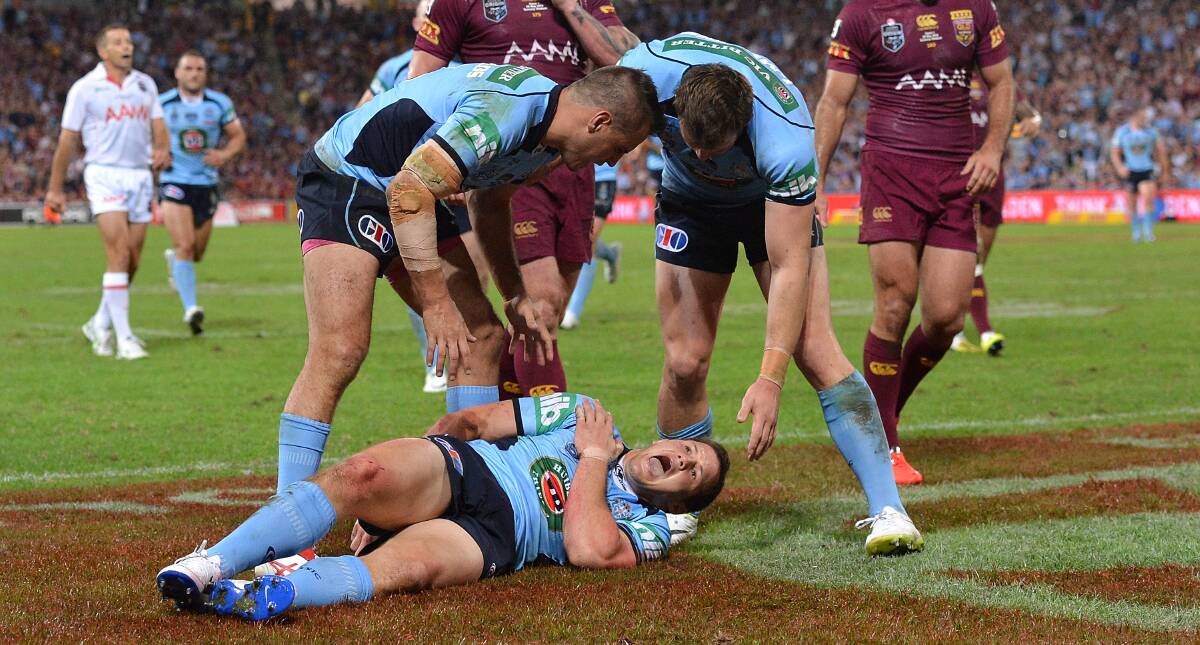 Brett Morris writhes in agony after scoring a try for the Blues in Origin I at Suncorp Stadium. Picture: GETTY IMAGES