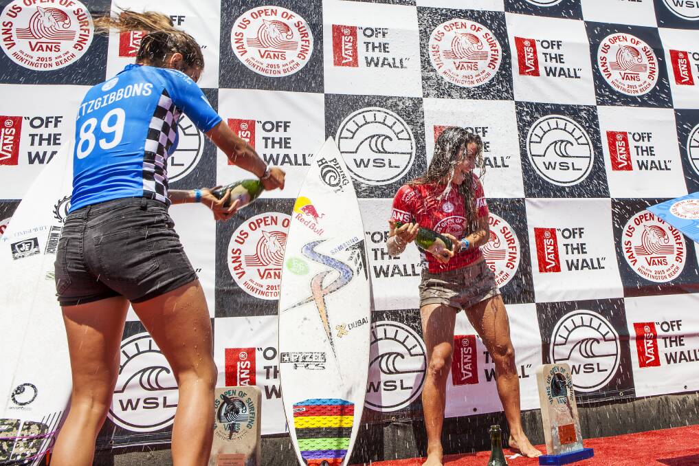 Second-placed Sally Fitzgibbons, left, and France's US Open winner Johanne Defay let fly with the obligatory champagne shower on the Huntington Beach podium. Picture: SEAN ROWLAND