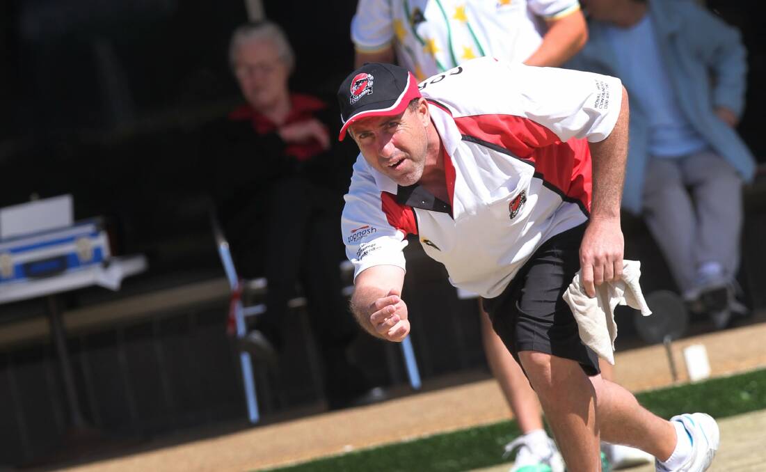 Nathan Severino plays his bowl in the final of the Illawarra Rookies Singles competition against Damien Harrison, rear, who triumphed 17-15. Picture: ORLANDO CHIODO