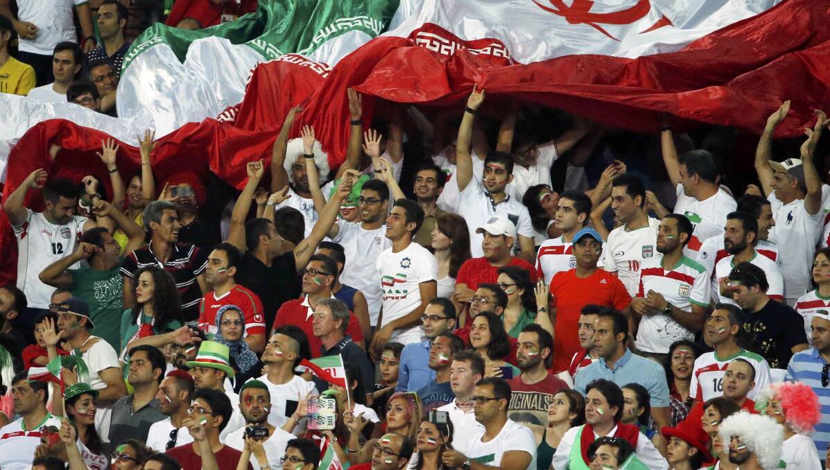 Iran supporters wave a large national flag during the Asian Cup Group C match against Qatar at Stadium Australia in Sydney on Thursday. Picture: REUTERS