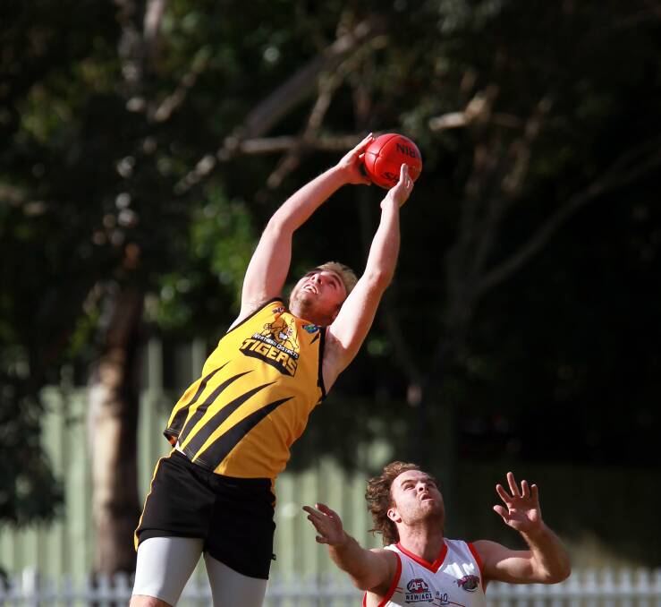 Northern Districts' Cameron Fraser takes a great mark in front of his Wollongong opponent in the Tigers' 53-point victory at Keira Oval. Picture: SYLVIA LIBER