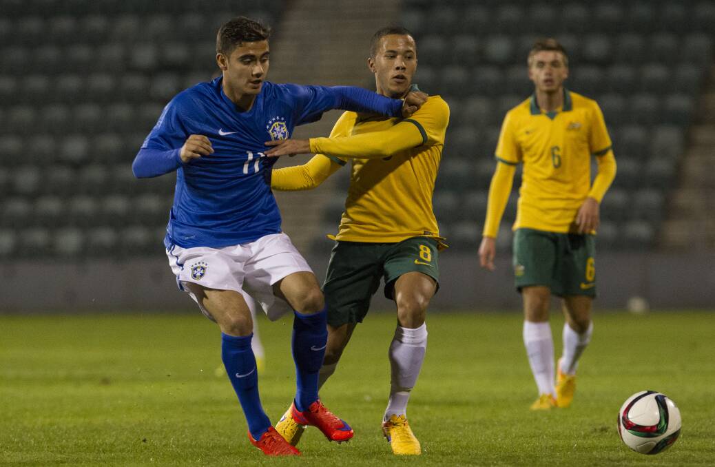 Brazil's Andreas Pereira battles for the ball with Young Socceroo Liam Youlley at WIN Stadium on Wednesday night. Picture: CHRISTOPHER CHAN