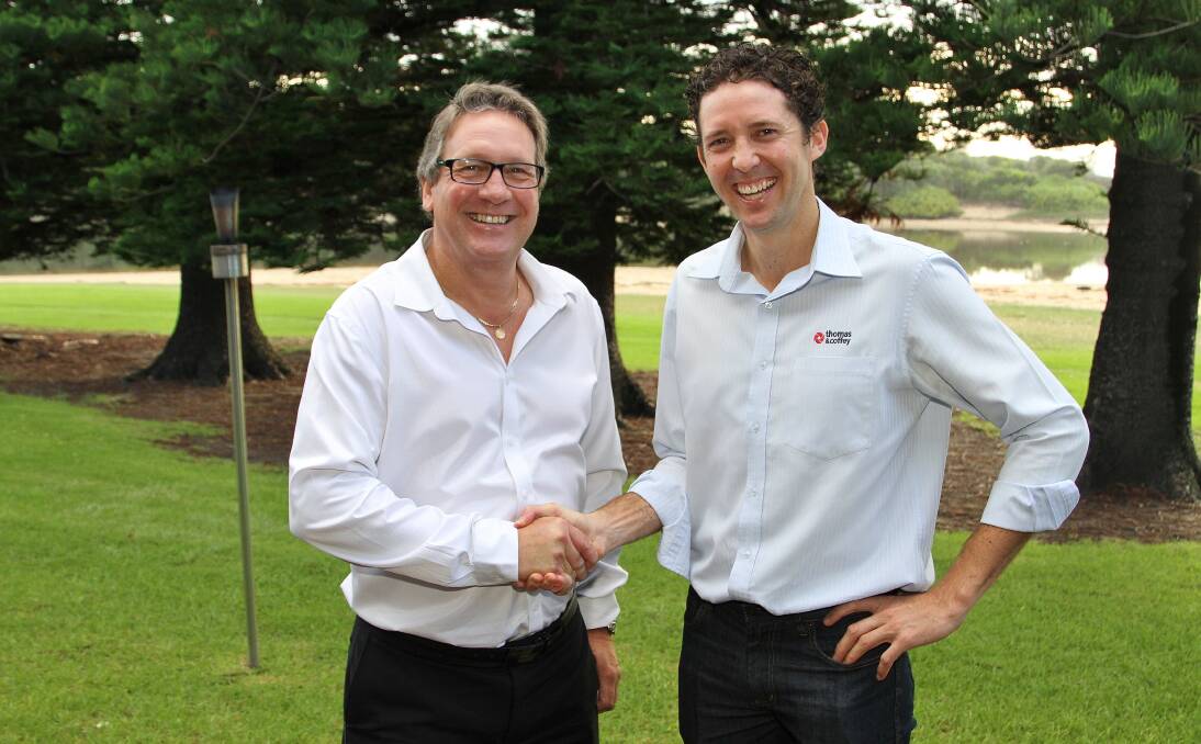 Phil Brodie, after 21 years in the Wollongong branch of Thomas & Coffey, passes the baton of management of the branch to Peter Buckley at the Illawarra Innovative Industry Network (i3net) April industry breakfast meeting. Picture: GREG ELLIS