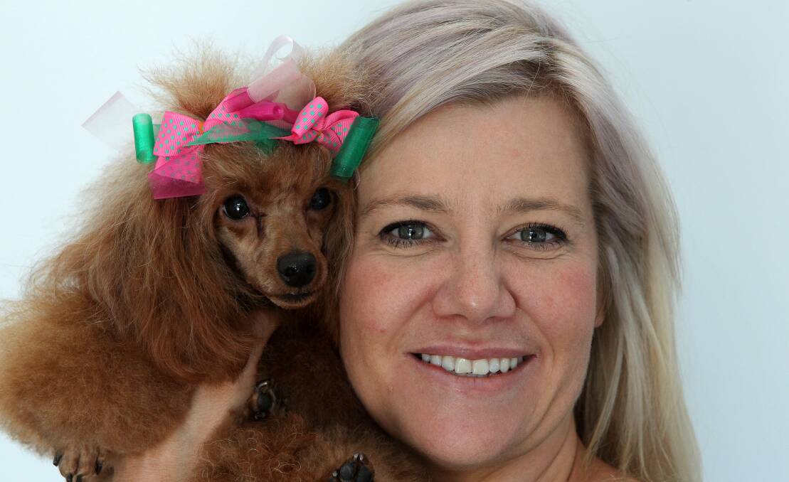 Greencross Vets dog groomer Riannan Jurriaans holds her French poodle Poppy, who is fully vaccinated. Picture: GREG TOTMAN