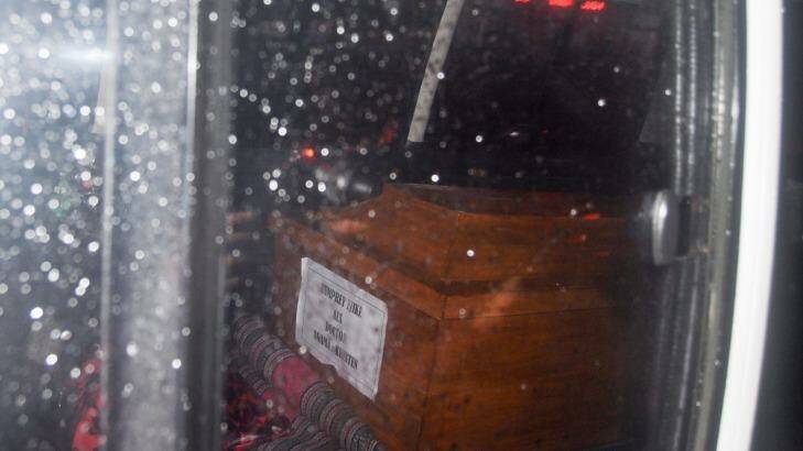 A coffin of one of the executed prisoners can be seen through the ambulance window transporting the bodies from Nusakambangan. Photo: Wagino