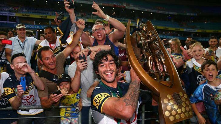 Cowboys captain Johnathan Thurston poses with the Premiership trophy after winning the 2015 NRL Grand Final. Photo: Cameron Spencer