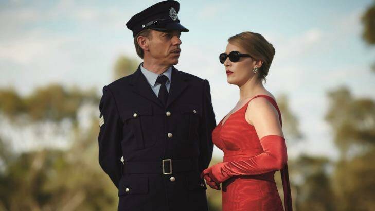 Woman in the red dress: Kate Winslet with Hugo Weaving in The Dressmaker.