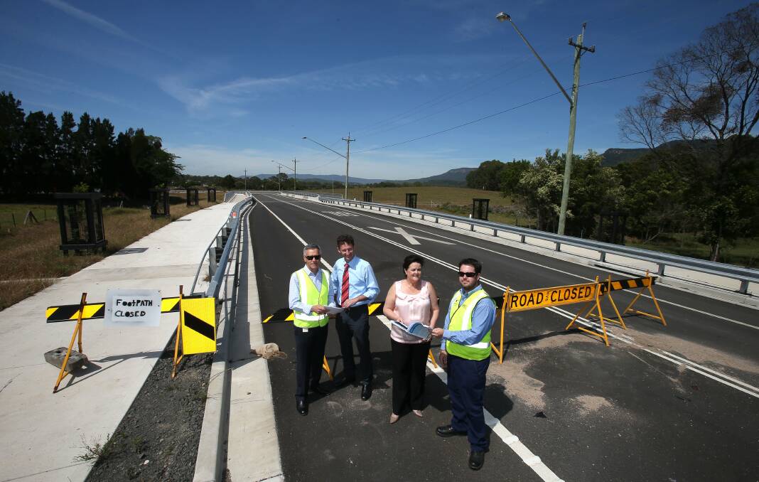 Wollongong City Council major projects manager Pas Silveri, MPs Stephen Jones and Anna Watson, and Chris Brown from the council check out the road upgrade designs. Picture: KIRK GILMOUR