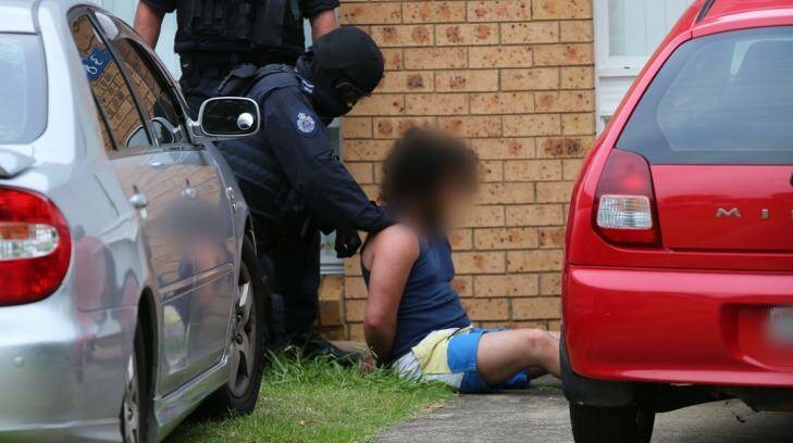 Counter-terrorism police arrest a male in Sydney's south-west on Thursday morning. Photo: NSW Police