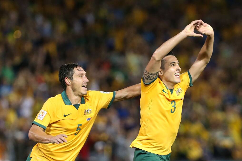 Australians Jason Davidson (right) and Mark Milligan celebrate a goal against United Arab Emirates on their way to the final. Picture: GETTY IMAGES