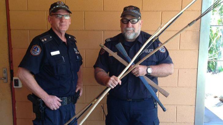 Acting Superintendent Steve Hayworth and Acting Senior Sergeant Owen Blackwell with a small number of the weapons confiscated following the fatal brawl. Photo: Northern Territory Police