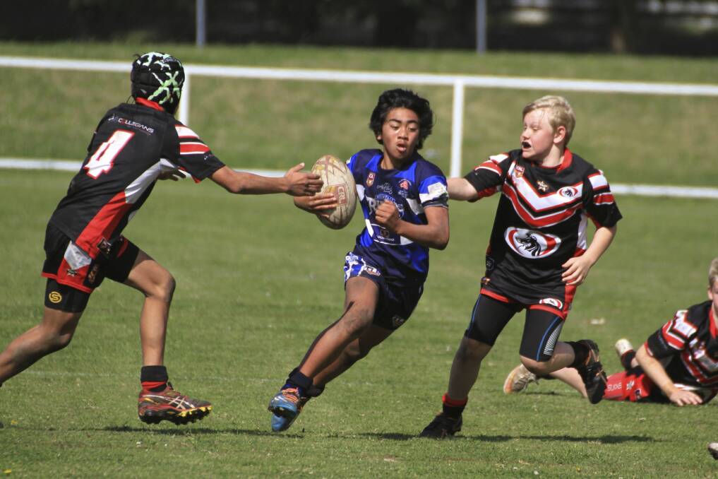 Break: A Huntley attacker tries to slice through a gap against Collegians in the 13 years division 1 Merged League final. Huntley won 30-8 and take on Western Suburbs in the grand final. Picture: ALLAN BARRY