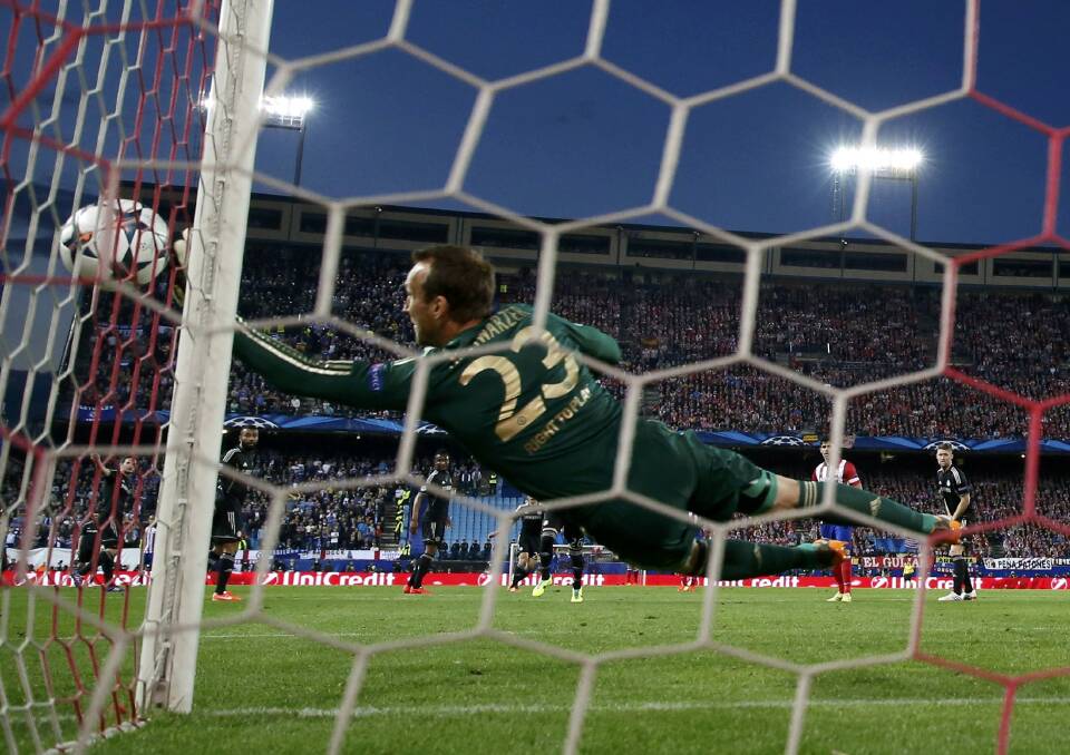 Safe: Chelsea's goalkeeper Mark Schwarzer edges the ball wide of the post against Atletico Madrid in Madrid this week. Picture: REUTERS