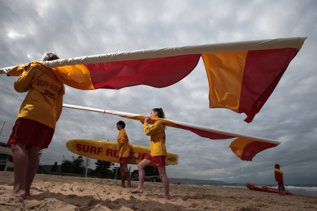 Illawarra's volunteer surf lifesavers Lachlan Kimberley, Tim Tapia and Eliza Gottaas-Healey at North Wollongong Beach on Sunday. Picture: ADAM McLEAN