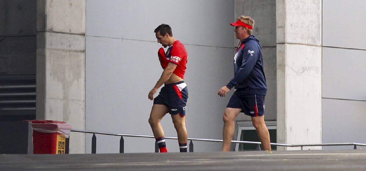 Mitchell Pearce leaves Roosters' training on Monday with Trent Robinson. Picture: BRENDAN ESPOSITO