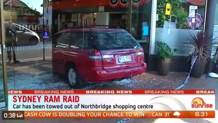 The car used during a ram raid is removed from Northbridge Plaza shopping centre. Photo: Seven News