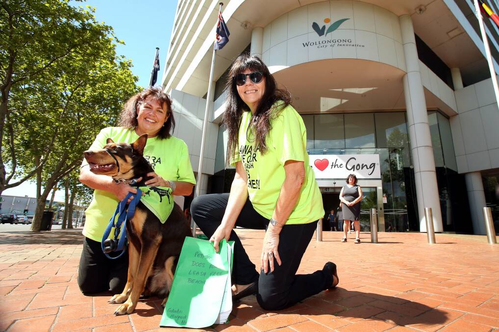 From left, Margaret Wall and Diana Messum with Oskar the kelpie about to deliver a petition to Ann Martin. Picture: KIRK GILMOUR