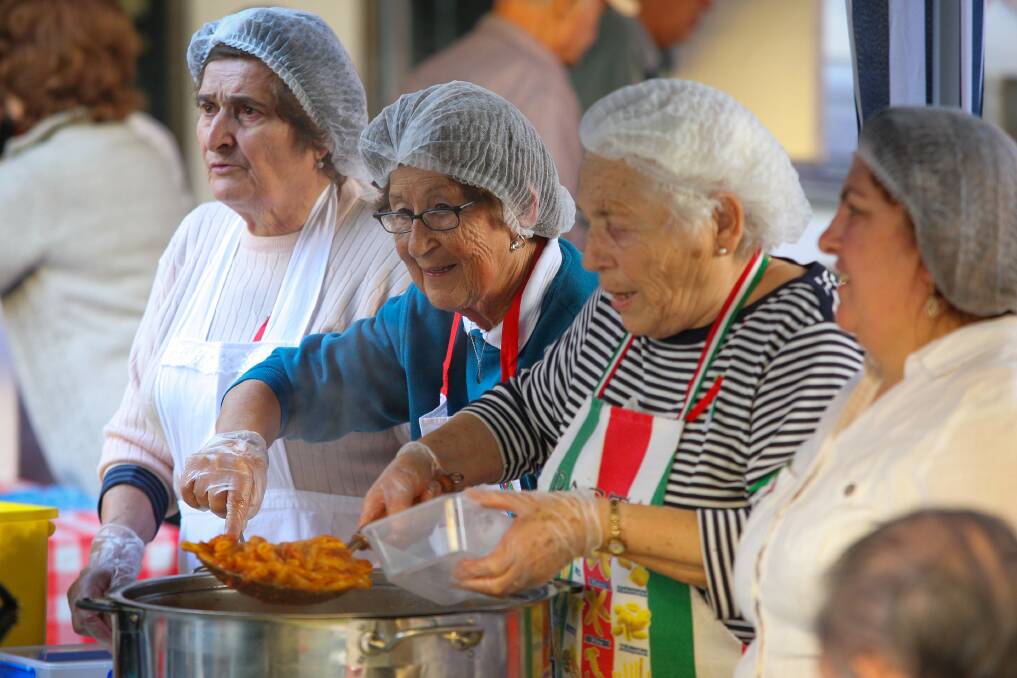 Women serve up pasta in the Crown Street Mall on Saturday. Picture: ADAM McLEAN