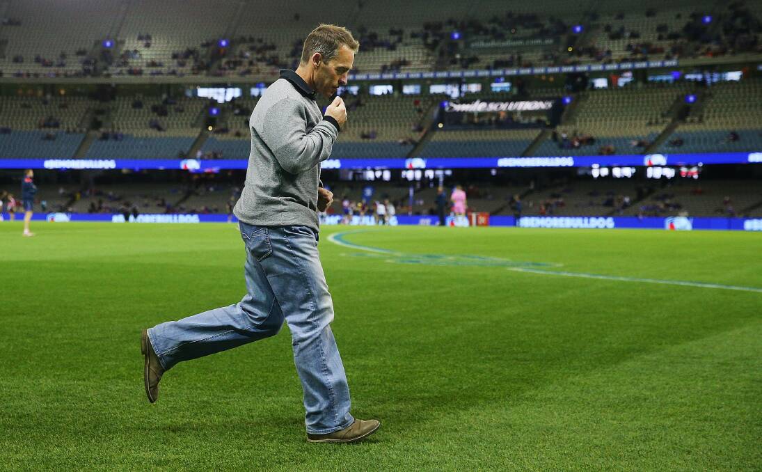 Hawks head coach Alastair Clarkson runs off the ground at Etihad Stadium after the match. Picture: GETTY IMAGES