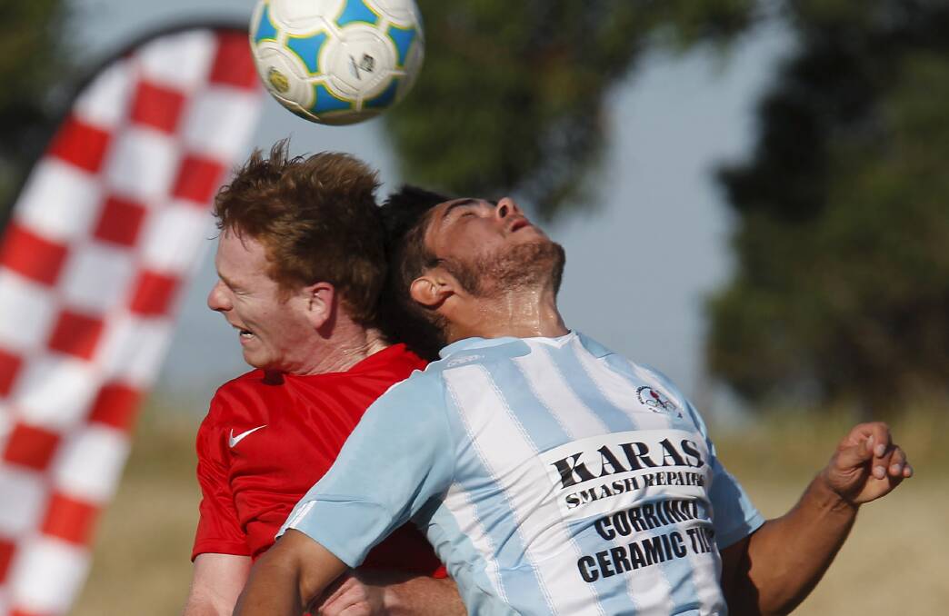 Topsy-turvey displays: Lachlan O'Connor of South Coast battles with Olympic's Jake Duczynski for possession. Picture: ANDY ZAKELI