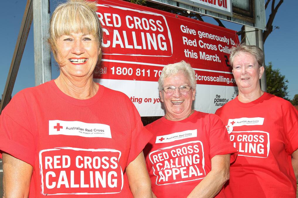 Dapto Red Cross secretary Sharon Clarke, assistant secretary Robyn Kershaw and treasurer Bonnie Leach get ready for the family fun day at Dapto Citizens Bowling Club on Sunday. Picture: GREG TOTMAN