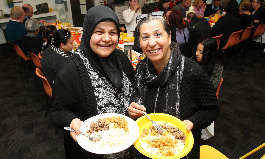 As one: Members of Illawarra's Islamic community, Fatma Ismail and Nurhan As, at the iftar dinner at the Homeless Hub. Picture: GREG TOTMAN