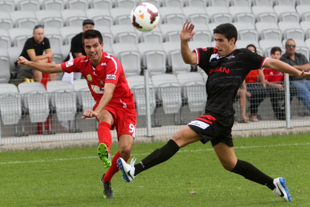 South Coast Wolves's Peter Simonoski challenges for the ball with Blacktown's Giorgio Speranza in this year's season opener at WIN Stadium. Picture: GREG TOTMAN