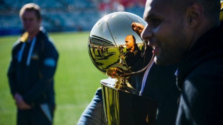 Patrick 'Patty' Mills visits the Brumbies at their training session at GIO Stadium ahead of their clash against the Chiefs.
Patrick Mills and Fotu Auelua reflected in the NBA trophy.
 Photo: Rohan Thomson