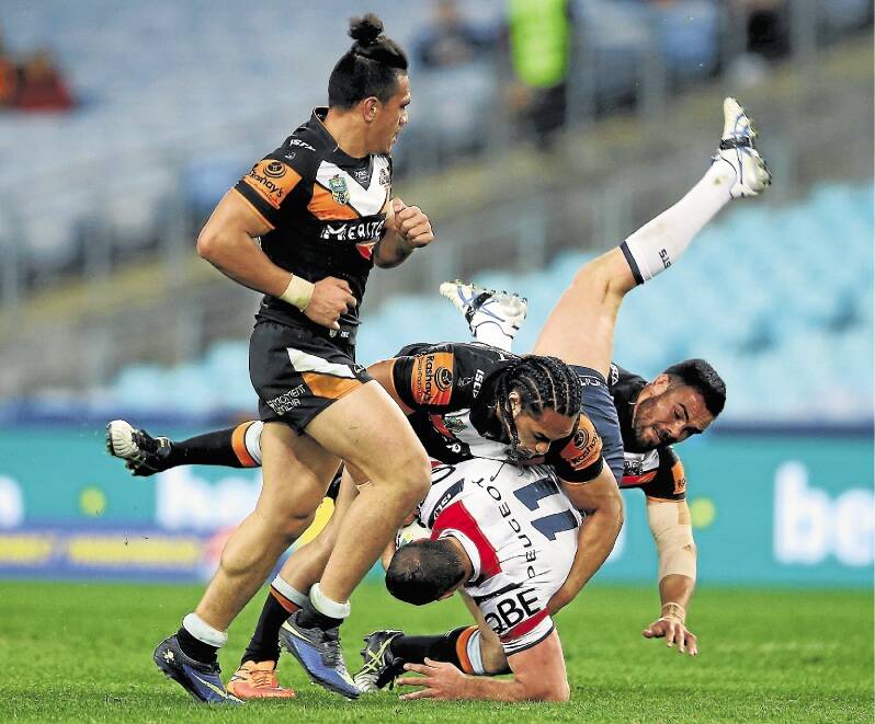 SYDNEY, AUSTRALIA - JULY 24:  Boyd Cordner of the Roosters is tackled during the round 20 NRL match between the Wests Tigers and the Sydney Roosters at ANZ Stadium on July 24, 2015 in Sydney, Australia.  (Photo by Mark Kolbe/Getty Images)