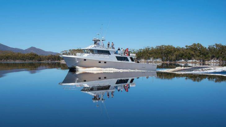 The Odalisque cruising the mirrored waters of Bathurst Harbour. Photo: Supplied