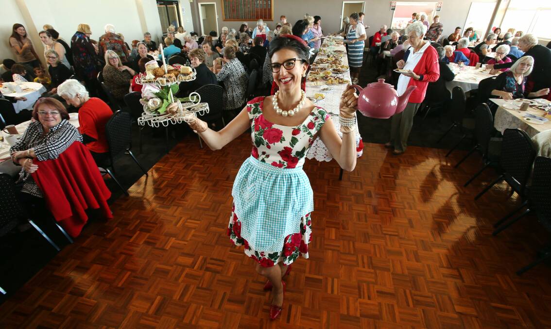 Refreshing: Letitia Sutherland serves tea and cake at the morning tea fund-raiser for Community Cancer Link at the Woonona Surf Club on Tuesday. Picture: ROBERT PEET