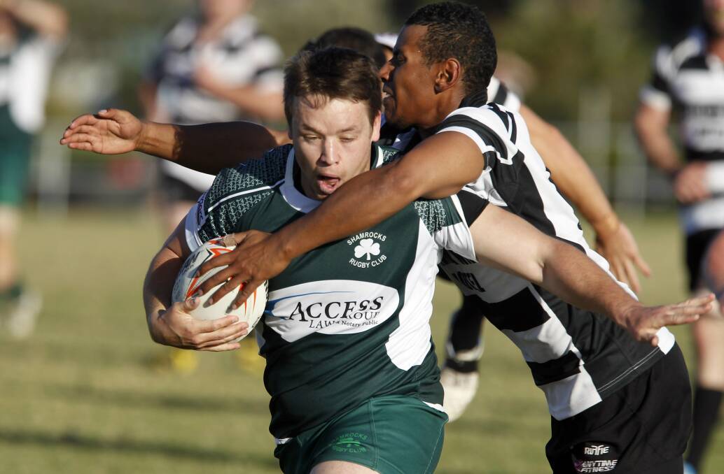 Shamrocks captain Tristan Storm is collared by Kiama’s Sam Moore on Saturday.  Picture: ANDY ZAKELI