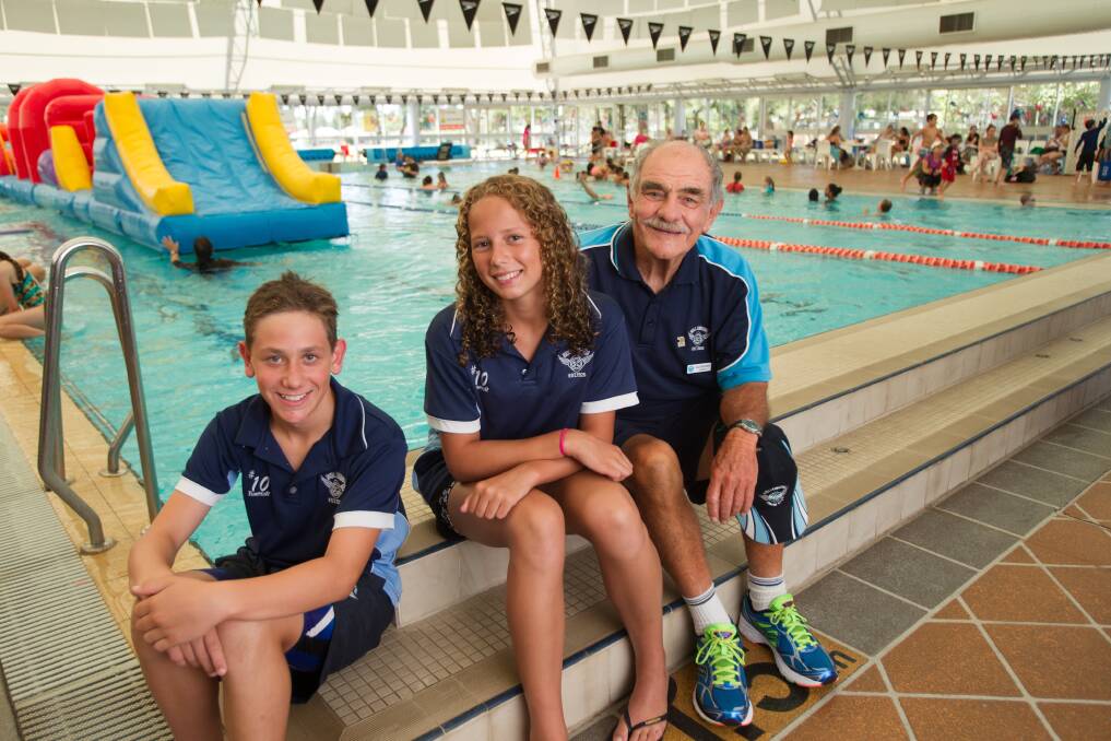 Wollongong Swim Club members Isaak Wilson, 12, and Georgia Robson, 14, with president Col Bruton at Beaton Park’s 25m pool. They want a 50-metre Olympic pool. Picture: CHRISTOPHER CHAN