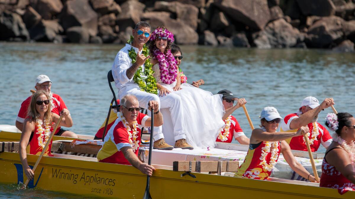 Hawaiian nuptials: Manii Verzosa and Tara St John Cox are transported to their wedding by the Wollongong Five Islands Outrigger Canoe Club.