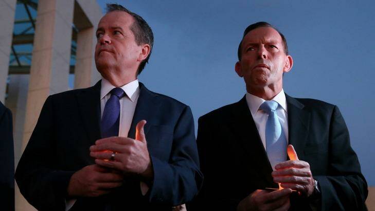 Opposition Leader Bill Shorten and Prime Minister Tony Abbott during the candlelight vigil. Photo: Alex Ellinghausen