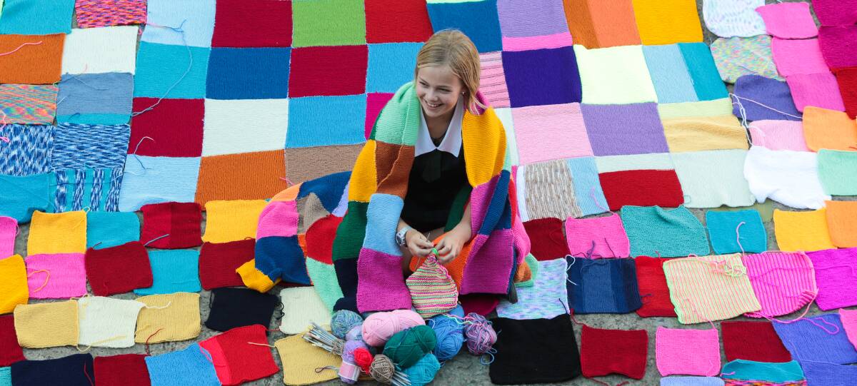 Colourful: Tamara Lilliendal with the hundreds of squares knitted by students. Picture: ADAM McLEAN