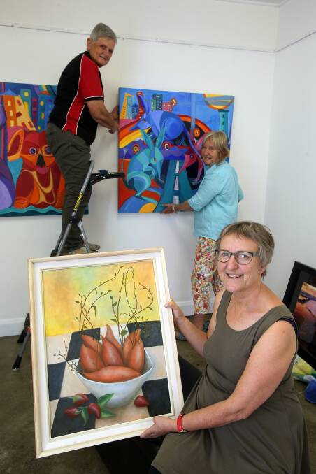 Red Point Artists members (back) Dulcie Dal Molin, Sue Buckton and (front) Kathryn Orton prepare for the group’s first Members’ Exhibition of 2015. Picture: ROBERT PEET