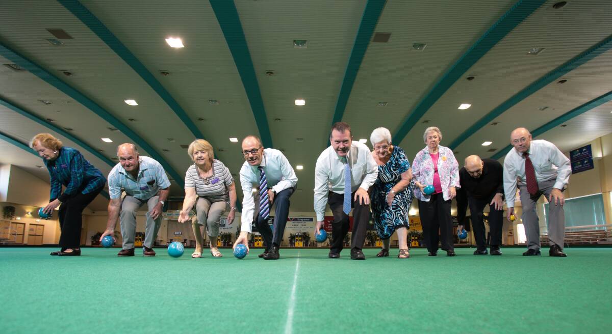Warrigal Care chief executive Mark Sewell and Warilla Bowls and Recreation Club chief executive Phillip Kipp ready themselves to play alongside Warrigal Care residents on the club's indoor bowling green. Picture: ADAM McLEAN
