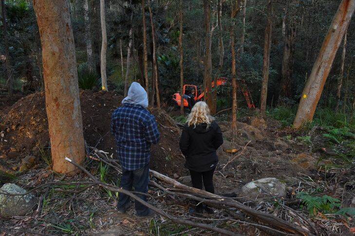 The parents of Matthew Leveson, Mark Leveson (left) and Faye Leveson (right) at the site where the search continues for the burial place of their son Matthew Leveson in the Royal National Park at Waterfall, NSW. 31st May, 2017. Photo: Kate Geraghty